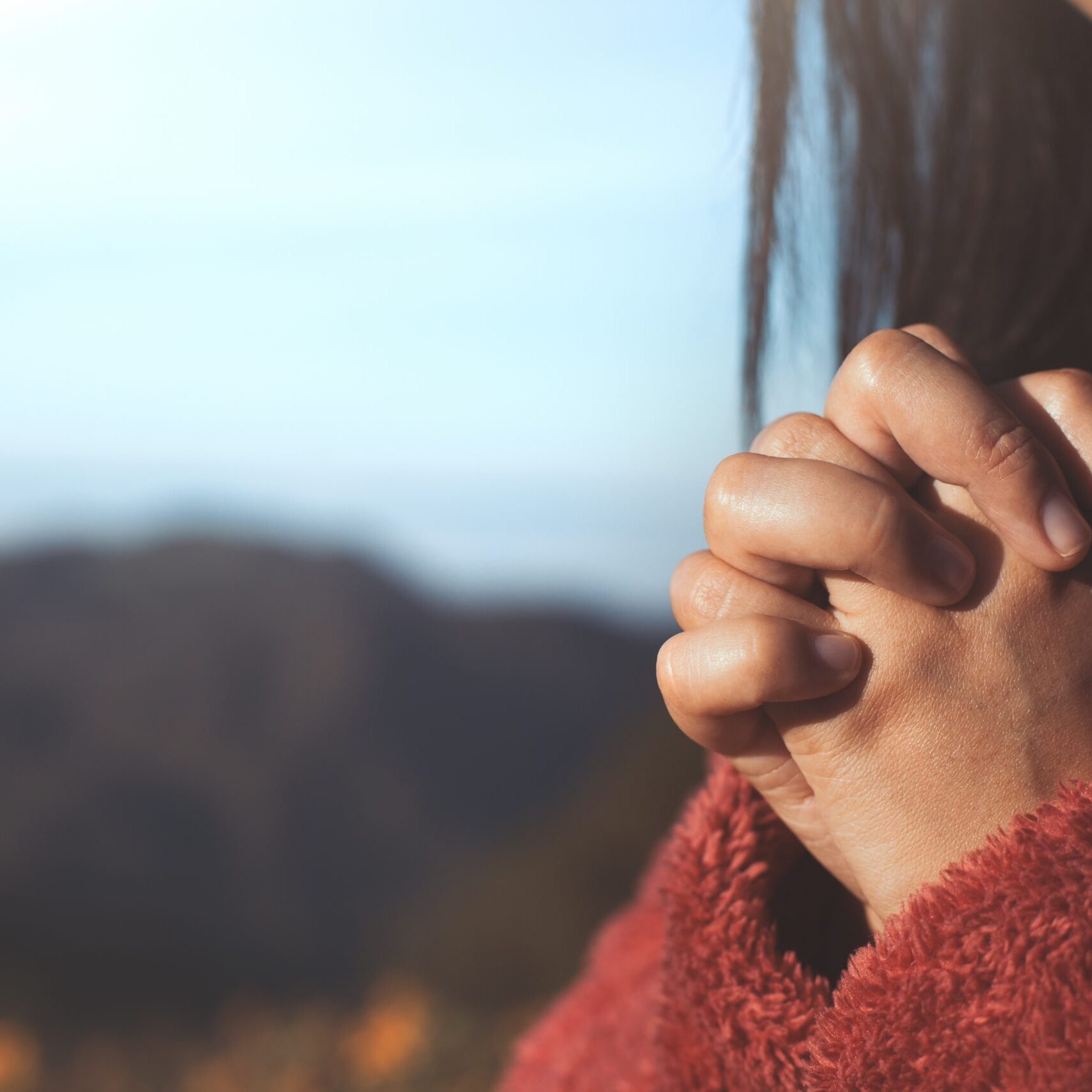 Woman,Hands,Folded,In,Prayer,In,Beautiful,Nature,Background,With